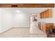 Open living room and kitchen with tile floor and wood beam at 8241 N Central Ave # 11, Phoenix, AZ 85020