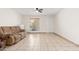 Living room featuring tile floors, a brown couch, and a dresser at 8241 N Central Ave # 11, Phoenix, AZ 85020