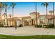 Grand estate entrance with circular driveway and palm trees at 10754 E Laurel Ln, Scottsdale, AZ 85259