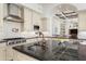 Modern kitchen with granite countertops, stainless steel appliances, and white cabinetry at 10754 E Laurel Ln, Scottsdale, AZ 85259