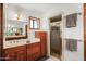 Bathroom features wood cabinets, a shower, and updated fixtures at 11426 E Cottontail Rd, Cave Creek, AZ 85331