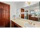 Vanity area with wood cabinets, large mirror, and updated fixtures at 11426 E Cottontail Rd, Cave Creek, AZ 85331