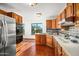 Kitchen features stainless steel appliances and wood cabinets with tile flooring and backsplash at 11426 E Cottontail Rd, Cave Creek, AZ 85331