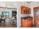 Built-in wet bar with wood cabinets and granite countertop at 11426 E Cottontail Rd, Cave Creek, AZ 85331