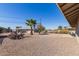 Large gravel backyard with small palms and desert landscaping is perfect for low maintenance at 12437 N Riviera Dr, Sun City, AZ 85351