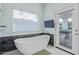 Bathroom with free-standing bathtub and access to private patio at 12528 N 78Th St, Scottsdale, AZ 85260