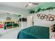 Bedroom with a large green bed and mirrored closet at 12528 N 78Th St, Scottsdale, AZ 85260