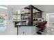 Modern kitchen with dark cabinetry and breakfast bar at 12528 N 78Th St, Scottsdale, AZ 85260