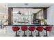 Sleek kitchen island with bar seating and dark cabinets at 12528 N 78Th St, Scottsdale, AZ 85260