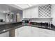 Well-equipped kitchenette featuring white cabinets and granite counters at 12528 N 78Th St, Scottsdale, AZ 85260