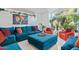 Open living room with teal sofa and orange armchairs at 12528 N 78Th St, Scottsdale, AZ 85260