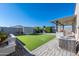 Spacious backyard with artificial turf, covered patio, and built-in BBQ at 12657 W Myrtle Ave, Glendale, AZ 85307