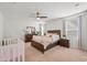 Primary bedroom with a crib and a bed with guard rails at 12657 W Myrtle Ave, Glendale, AZ 85307