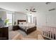 Spacious bedroom with a crib and a bed with guard rails at 12657 W Myrtle Ave, Glendale, AZ 85307