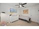 Bright bedroom with a twin bed, dresser, and ceiling fan at 12657 W Myrtle Ave, Glendale, AZ 85307