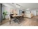 Elegant dining room with a rustic table, bench seating, and stylish light fixture at 12657 W Myrtle Ave, Glendale, AZ 85307
