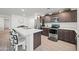 Modern kitchen featuring an island, stainless steel appliances, and ample cabinetry at 12657 W Myrtle Ave, Glendale, AZ 85307