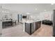 Modern kitchen with island, stainless steel appliances, and dining area at 12657 W Myrtle Ave, Glendale, AZ 85307