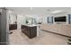 Open kitchen with island, dark cabinets, and view to living room at 12657 W Myrtle Ave, Glendale, AZ 85307