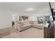 Open living room with a comfortable sectional sofa and view into the kitchen at 12657 W Myrtle Ave, Glendale, AZ 85307