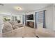 Spacious living room featuring a large sectional sofa and flat-screen TV at 12657 W Myrtle Ave, Glendale, AZ 85307