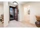 Bright entryway with tile flooring, decorative door, and coat closet at 12733 W Nogales Dr, Sun City West, AZ 85375