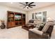 Living room with large entertainment center, comfortable seating, and tile floors at 12733 W Nogales Dr, Sun City West, AZ 85375