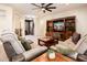 Relaxing living room featuring comfortable seating and built-in entertainment center at 12733 W Nogales Dr, Sun City West, AZ 85375