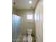 Clean bathroom with a toilet, shower, and small window at 13612 W Cypress St, Goodyear, AZ 85395