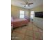 Spacious bedroom with large TV, dresser and ceiling fan at 13612 W Cypress St, Goodyear, AZ 85395