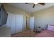 Bedroom with double door closet and ceiling fan at 13612 W Cypress St, Goodyear, AZ 85395