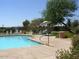 Inviting community pool with patio furniture and umbrellas at 13612 W Cypress St, Goodyear, AZ 85395