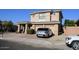 Tan two-story house with a two-car garage and landscaping at 13612 W Cypress St, Goodyear, AZ 85395