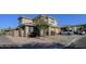 Two-story house with tan exterior, landscaped yard, and a two-car garage at 13612 W Cypress St, Goodyear, AZ 85395