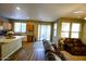 Open kitchen with granite island and access to backyard at 13612 W Cypress St, Goodyear, AZ 85395