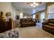 Living room with leather couches and view into kitchen at 13612 W Cypress St, Goodyear, AZ 85395