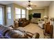 Living room with leather couches and a ceiling fan at 13612 W Cypress St, Goodyear, AZ 85395