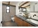 Contemporary bathroom with double vanity and exposed brick feature wall at 1442 E Rancho Dr, Phoenix, AZ 85014