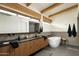 Modern bathroom with double vanity, soaking tub, and dark tile at 1442 E Rancho Dr, Phoenix, AZ 85014