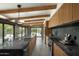 Open concept kitchen with island, dark countertops, and pool view at 1442 E Rancho Dr, Phoenix, AZ 85014