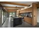 Modern kitchen with large island, wood cabinetry, and stainless steel appliances at 1442 E Rancho Dr, Phoenix, AZ 85014