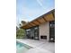 Outdoor patio with fireplace adjacent to the pool at 1442 E Rancho Dr, Phoenix, AZ 85014