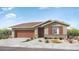 Single-story home with brown garage doors and brick accents at 14832 W Cottontail Ln, Surprise, AZ 85387