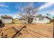 Large, sunny backyard featuring a leafless shade tree and detached garage at 14846 N 29Th Ave, Phoenix, AZ 85053