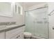 Bright bathroom with a granite vanity top, glass shower door, and white toilet at 14846 N 29Th Ave, Phoenix, AZ 85053
