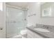 Updated bathroom with glass-enclosed shower and granite vanity at 14846 N 29Th Ave, Phoenix, AZ 85053