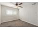 Neutral carpet, ceiling fan, and window in a simple yet functional bedroom at 14846 N 29Th Ave, Phoenix, AZ 85053