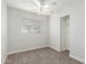 Bedroom features neutral carpet, ceiling fan with light, and window for great natural light at 14846 N 29Th Ave, Phoenix, AZ 85053