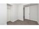 Bright bedroom with neutral carpet, closet with shelf and open door to hall at 14846 N 29Th Ave, Phoenix, AZ 85053