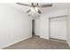 Bright bedroom with neutral carpet, closet with sliding doors, and overhead fan at 14846 N 29Th Ave, Phoenix, AZ 85053